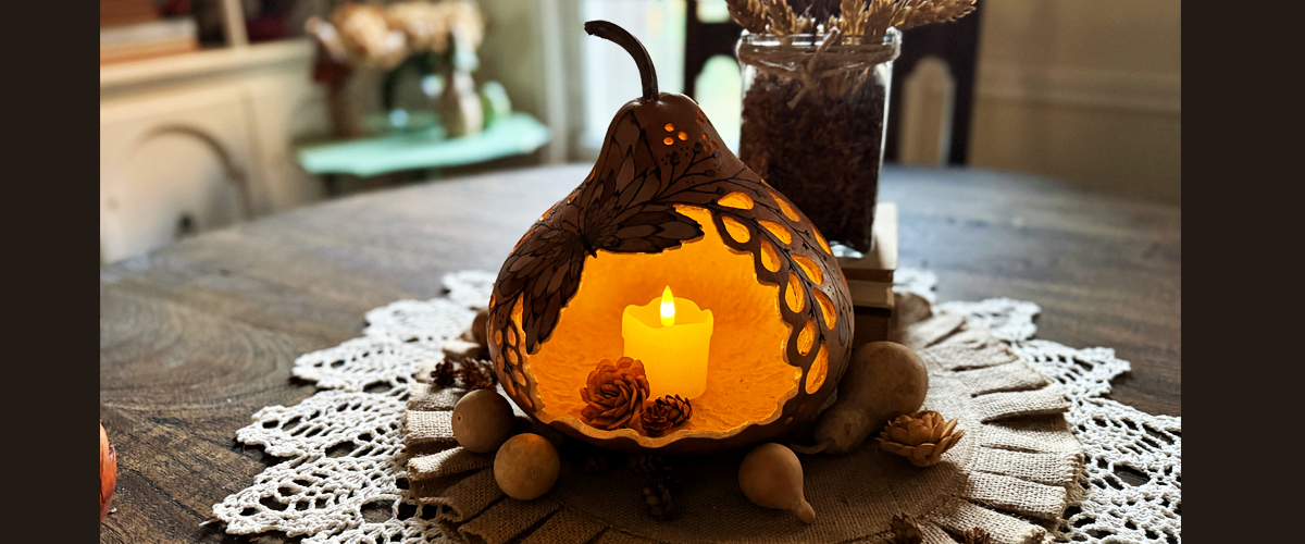 Butterfly gourd luminary glowing with warm candlelight