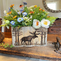 wood box centerpiece Floral arrangement in a wooden pot with moose design on a wooden surface