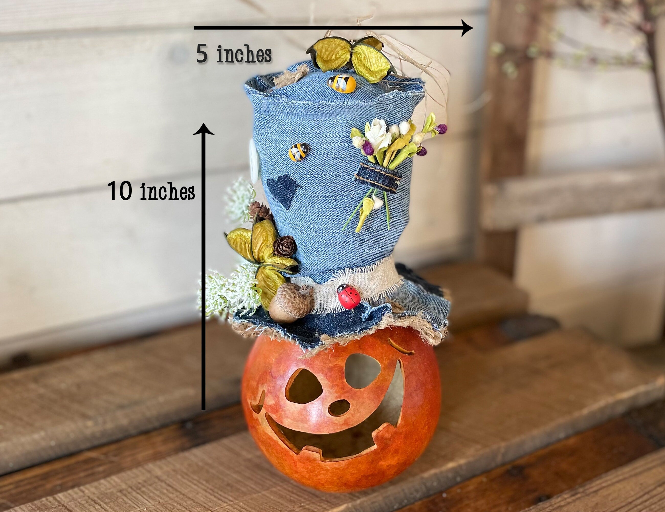 Decorative item with denim top and pumpkin base on a wooden surface