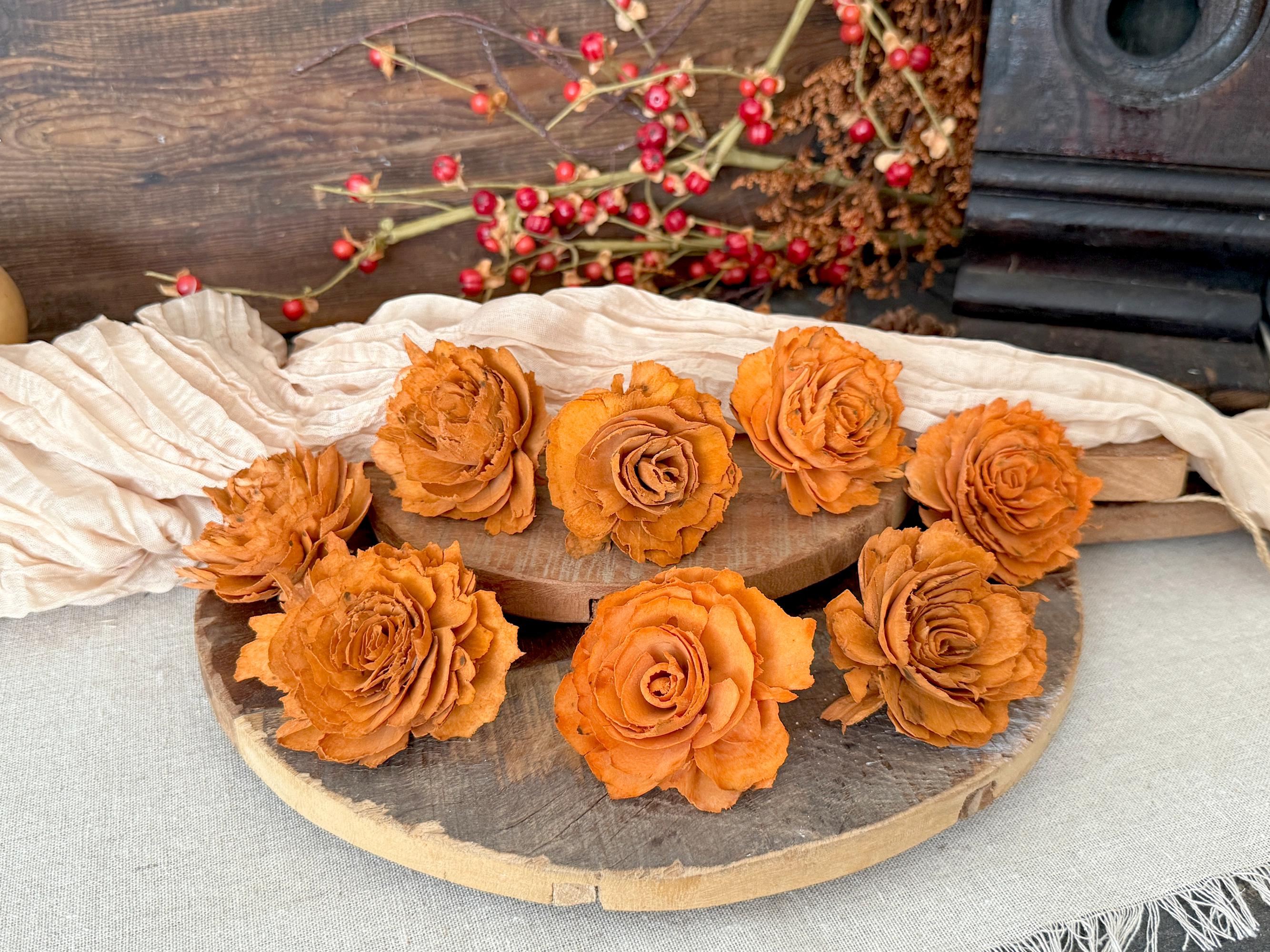 wood orange roses on a wooden board with a rustic background