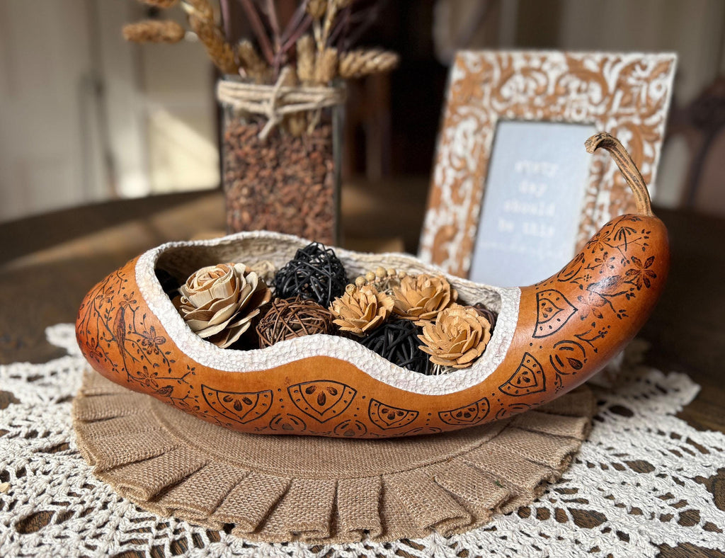 Decorative brown shell-shaped bowl with flowers on a lace tablecloth
