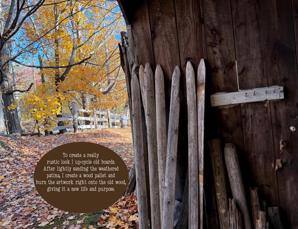 Wooden boards leaning against a wooden wall with autumn trees in the background
