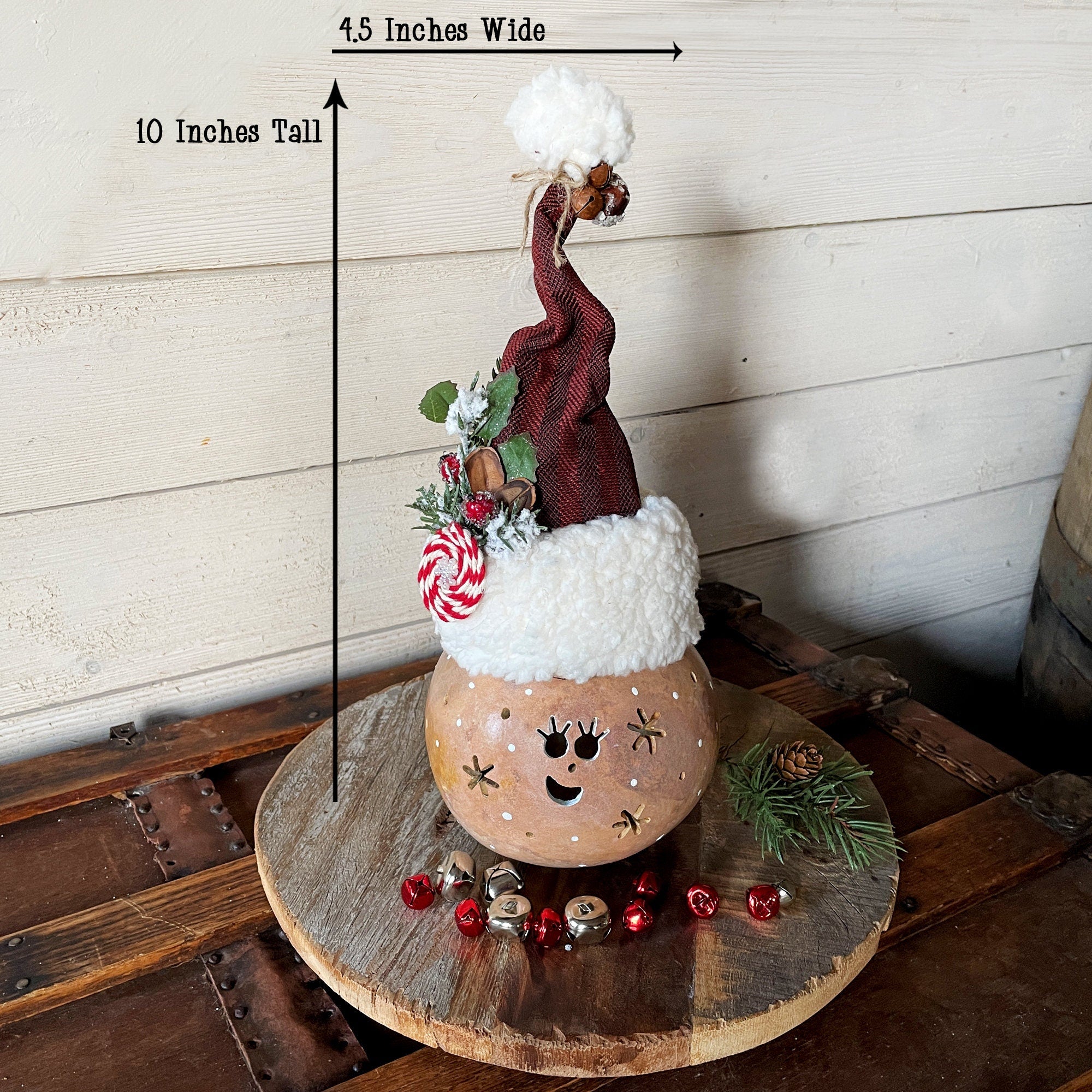 Decorative Christmas-themed light fixture with measurements on a wooden surface.