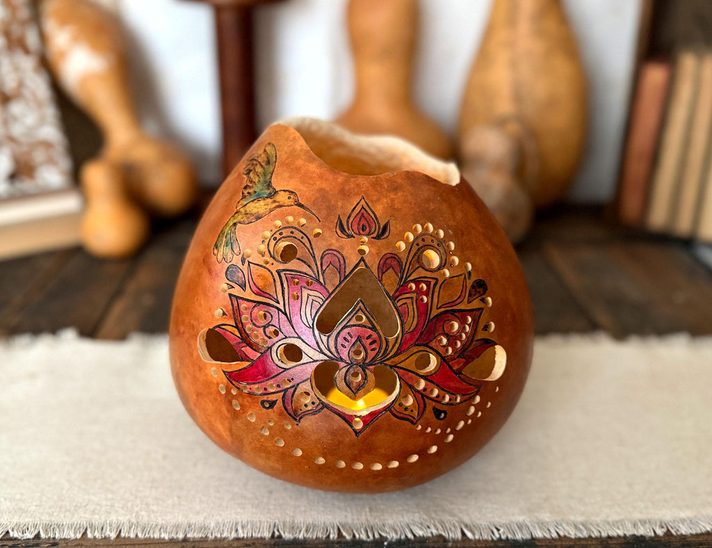 Decorative gourd with intricate designs on a white surface