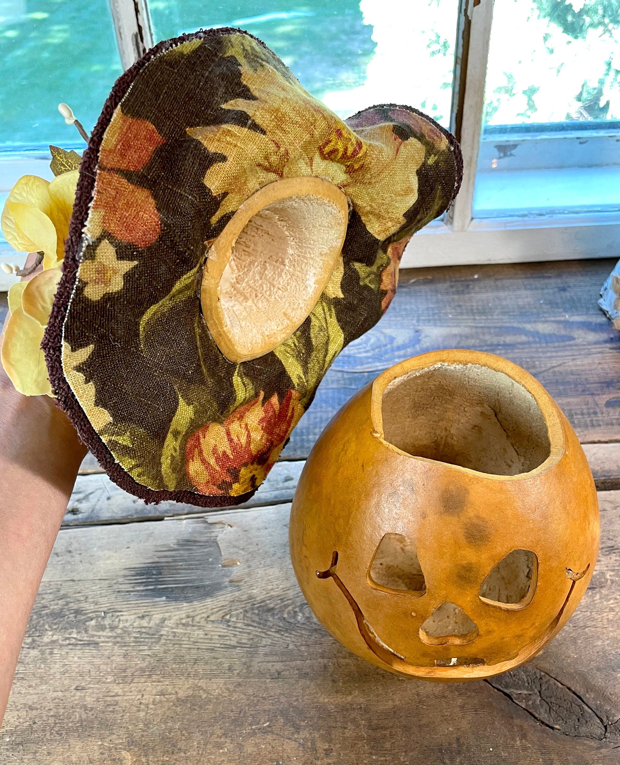 Decorative pumpkin with a floral pattern on a wooden surface