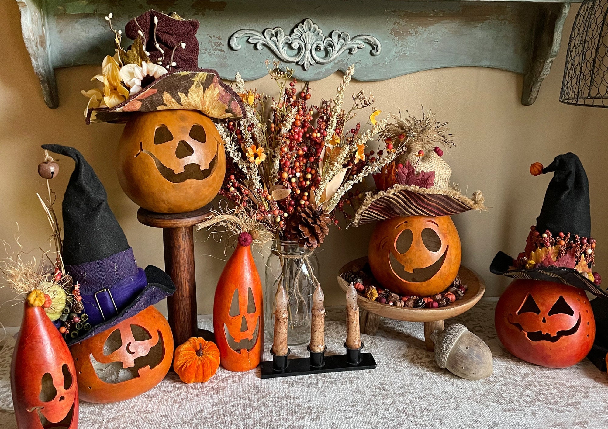Halloween-themed decorations including pumpkins and witch hats on a shelf.