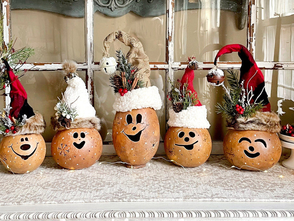 Decorative pumpkins with smiling faces on a mantelpiece.