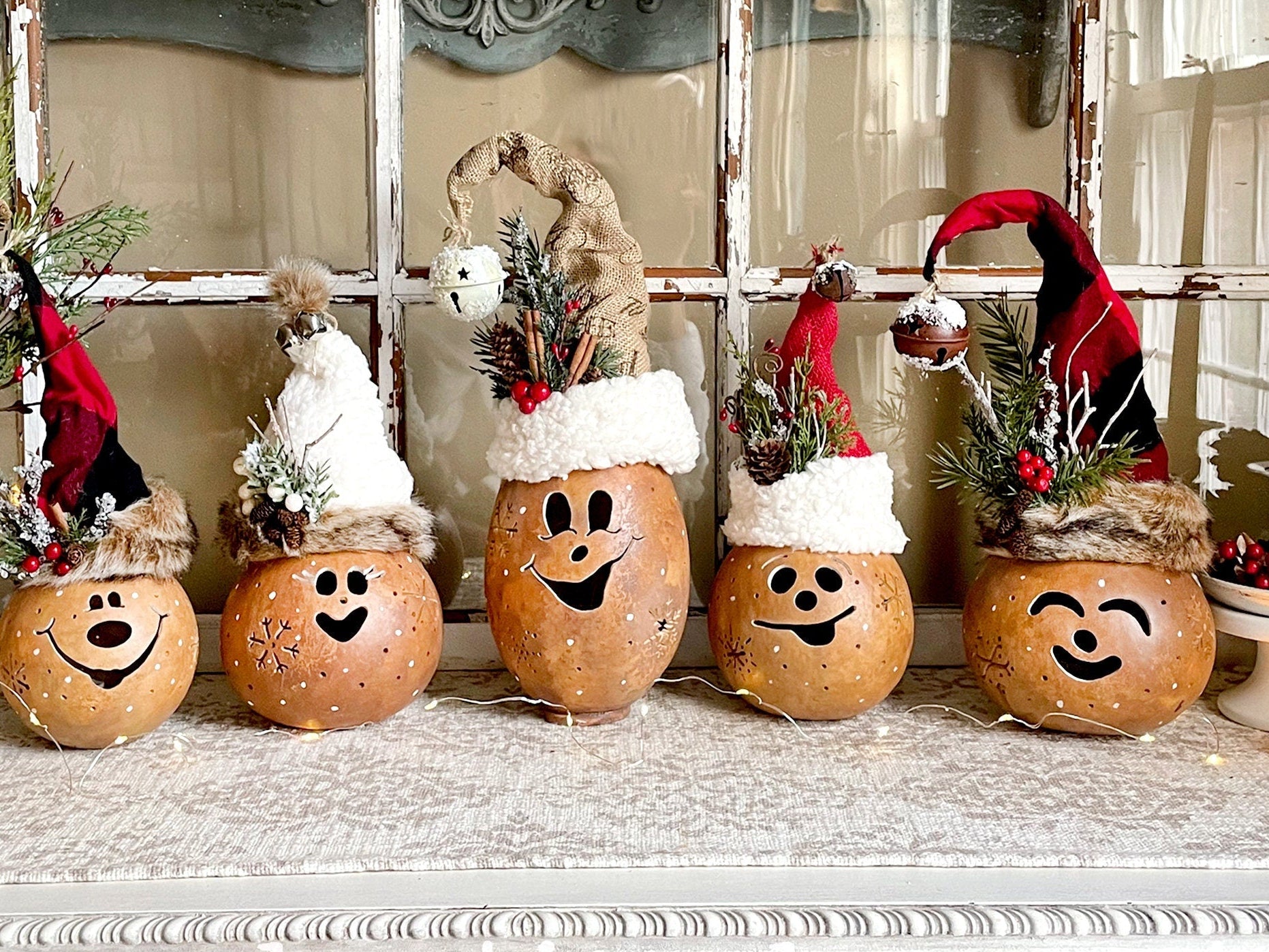 Decorative pumpkins with smiling faces on a mantelpiece.