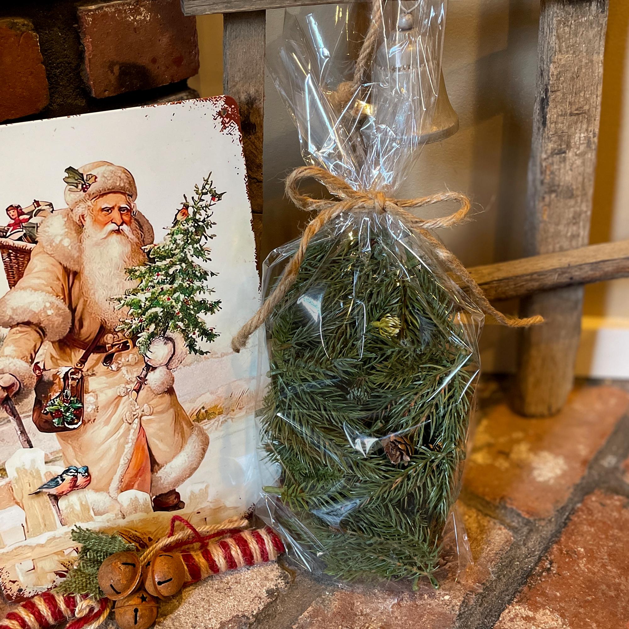 Packaged Christmas tree with Santa Claus illustration on a rustic background