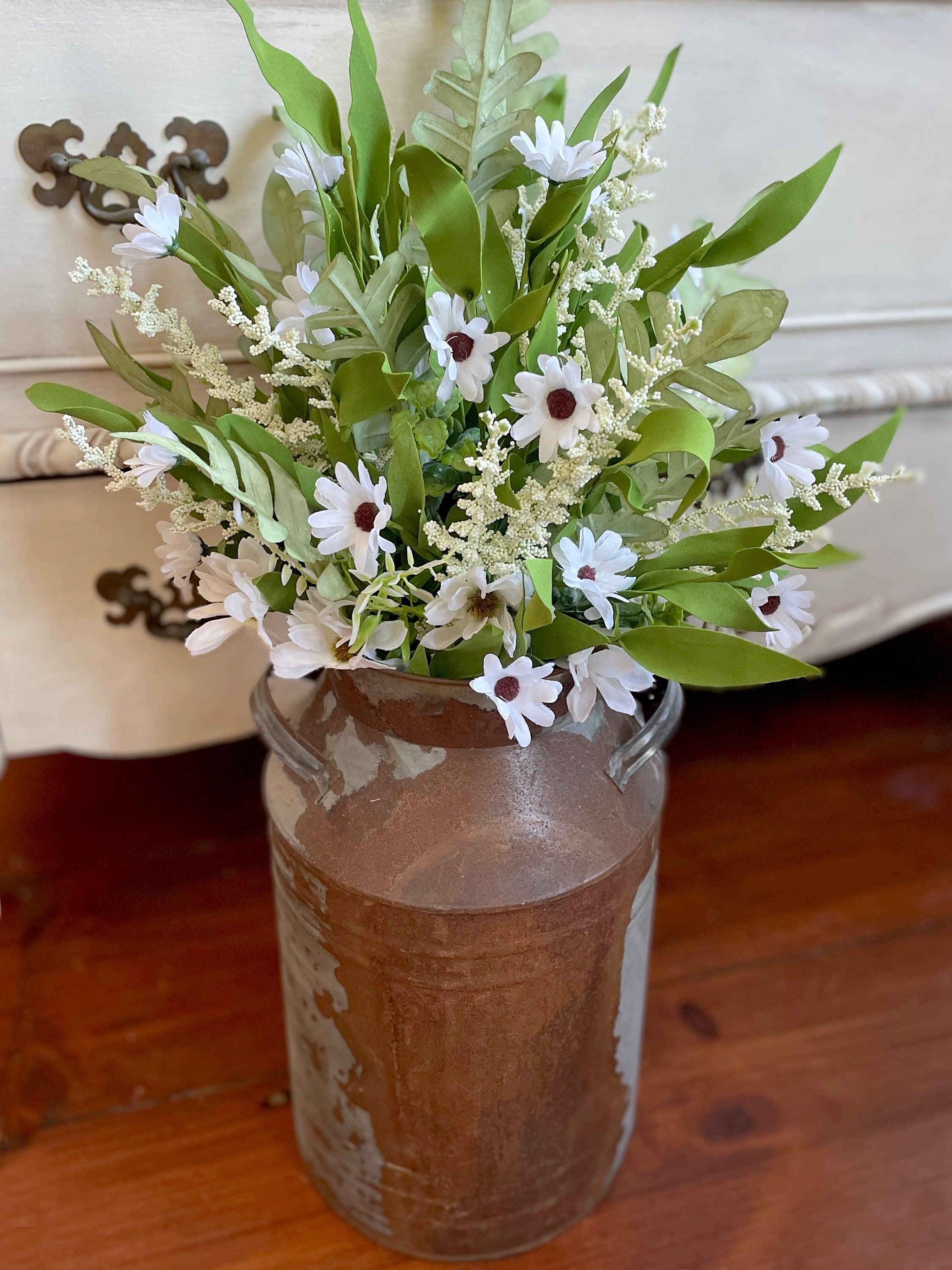 Decorative vase with flowers on a wooden surface
