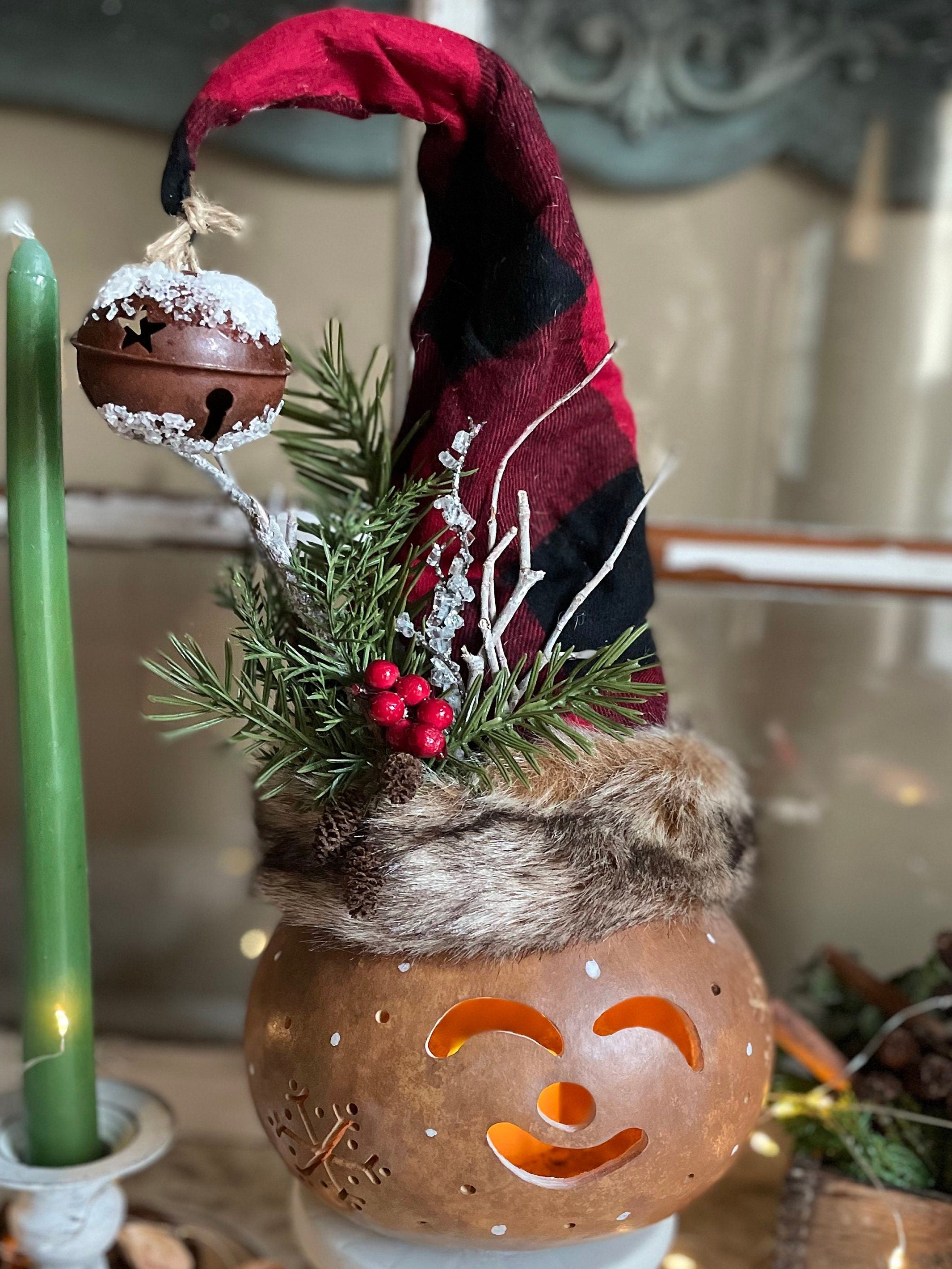 Decorative gnome with a red hat and green candle, featuring a rustic aesthetic.
