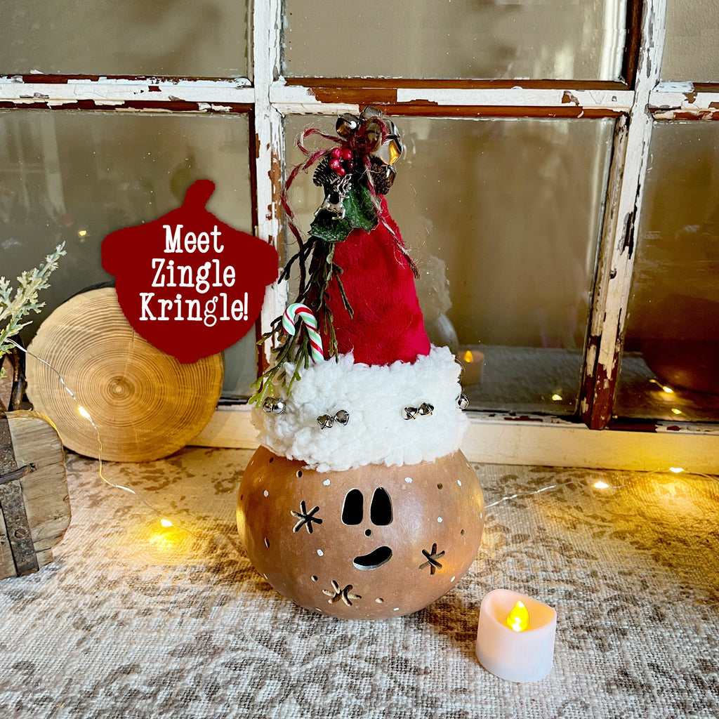 Decorative Christmas lantern with a reindeer figure and text 'Meet Zingle Kringle' on a textured surface.