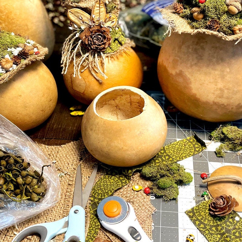 Decorative pumpkins with craft supplies on a table