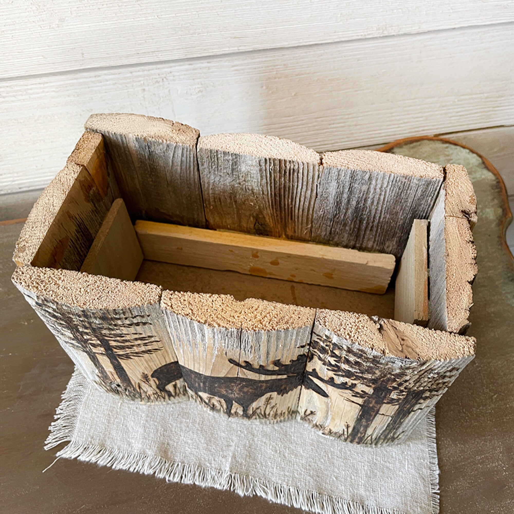 Wooden basket with natural finish and fabric lining on a wooden surface