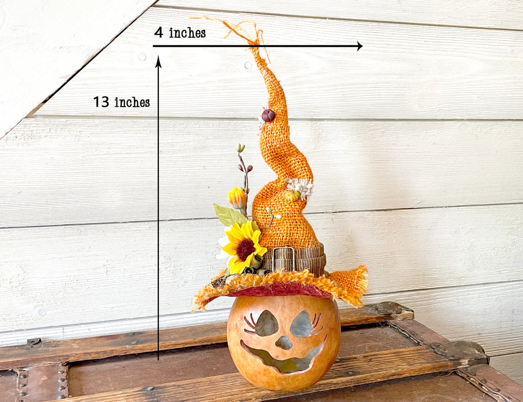 Decorative corn sculpture on a pumpkin with measurements indicated