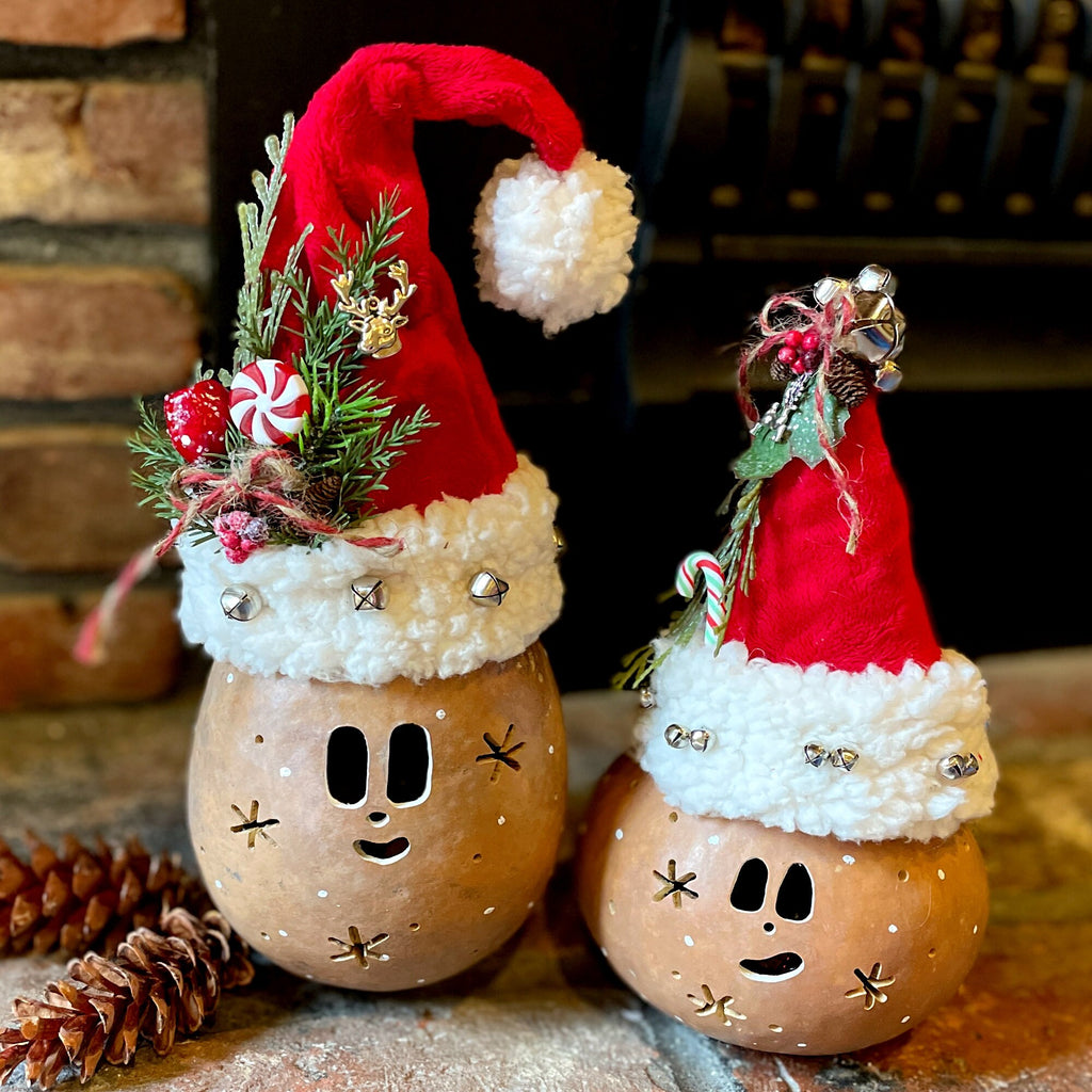 Two decorative bottles with Santa hats and Christmas elements on a rustic background