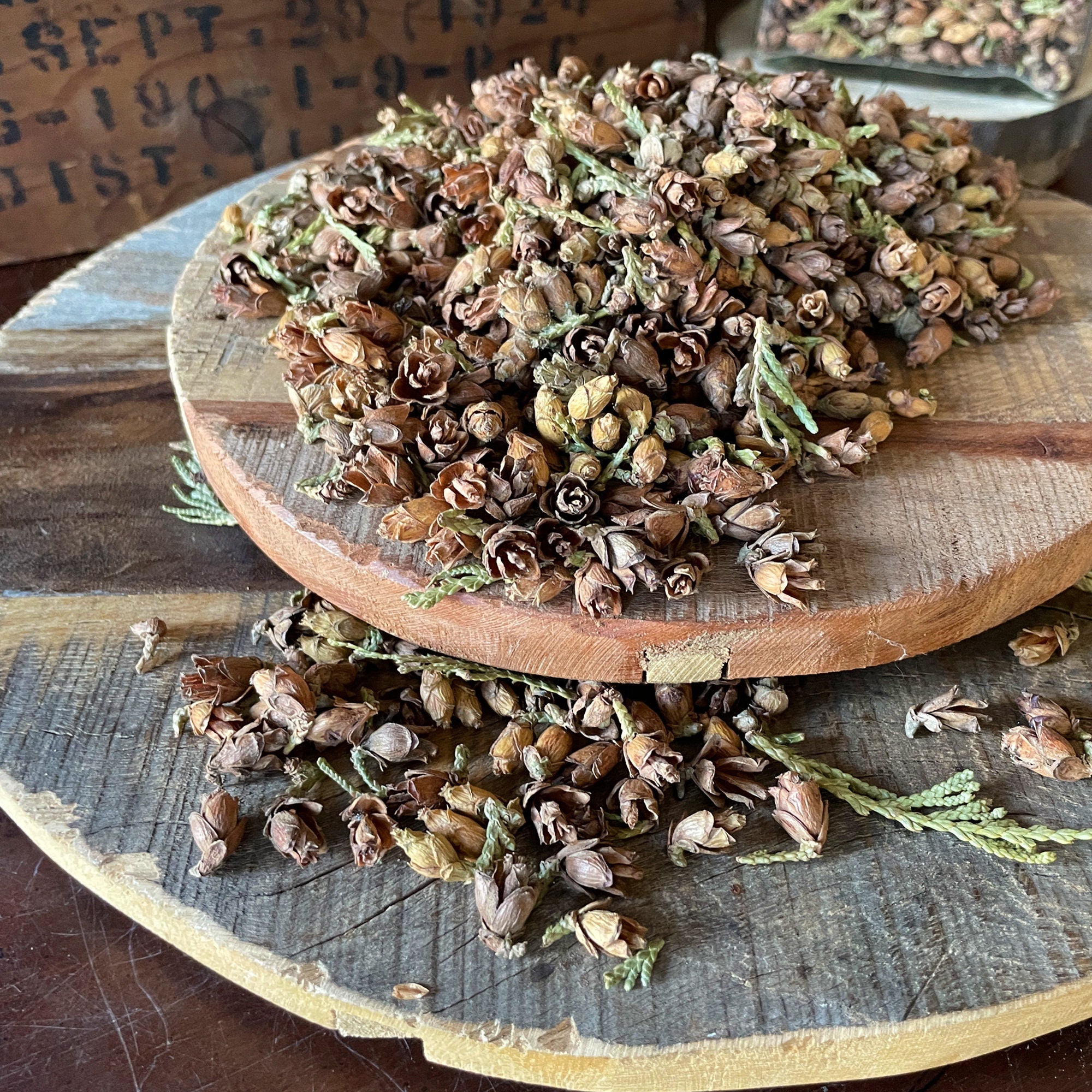 Dried herbs on a wooden cutting board with a rustic background