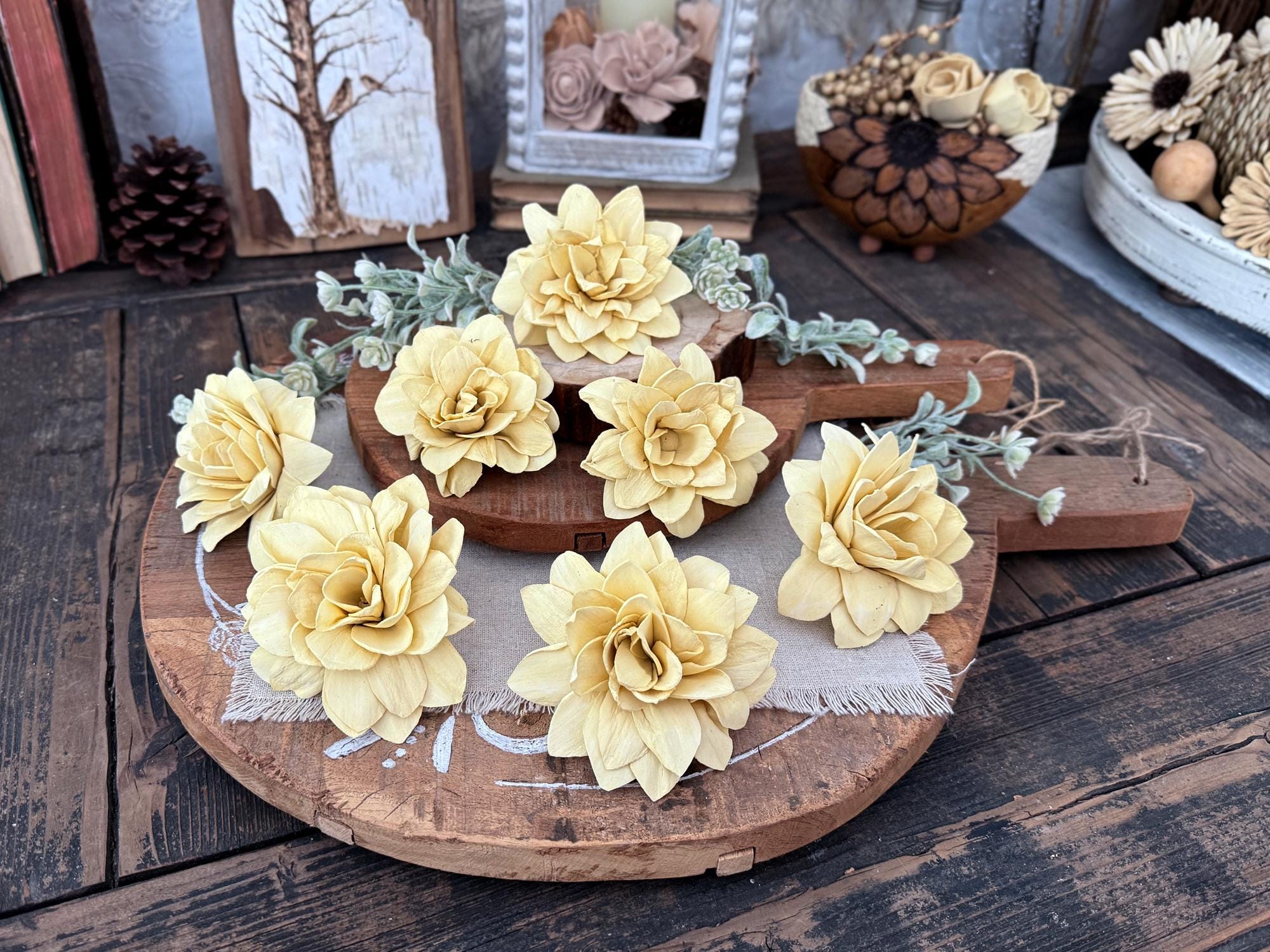 Decorative wooden board with yellow flowers on a rustic wooden surface