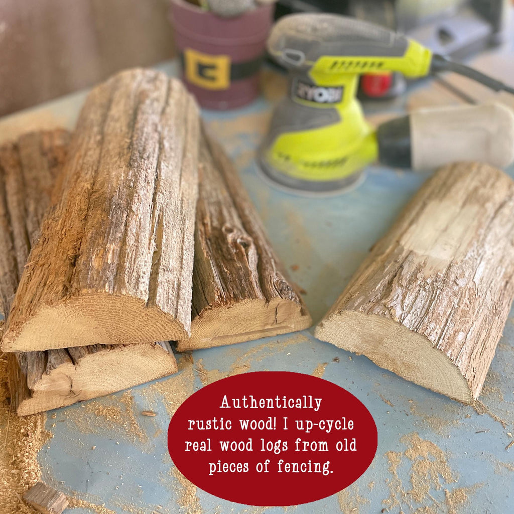 Three pieces of rustic wood logs on a workbench with a power tool in the background.