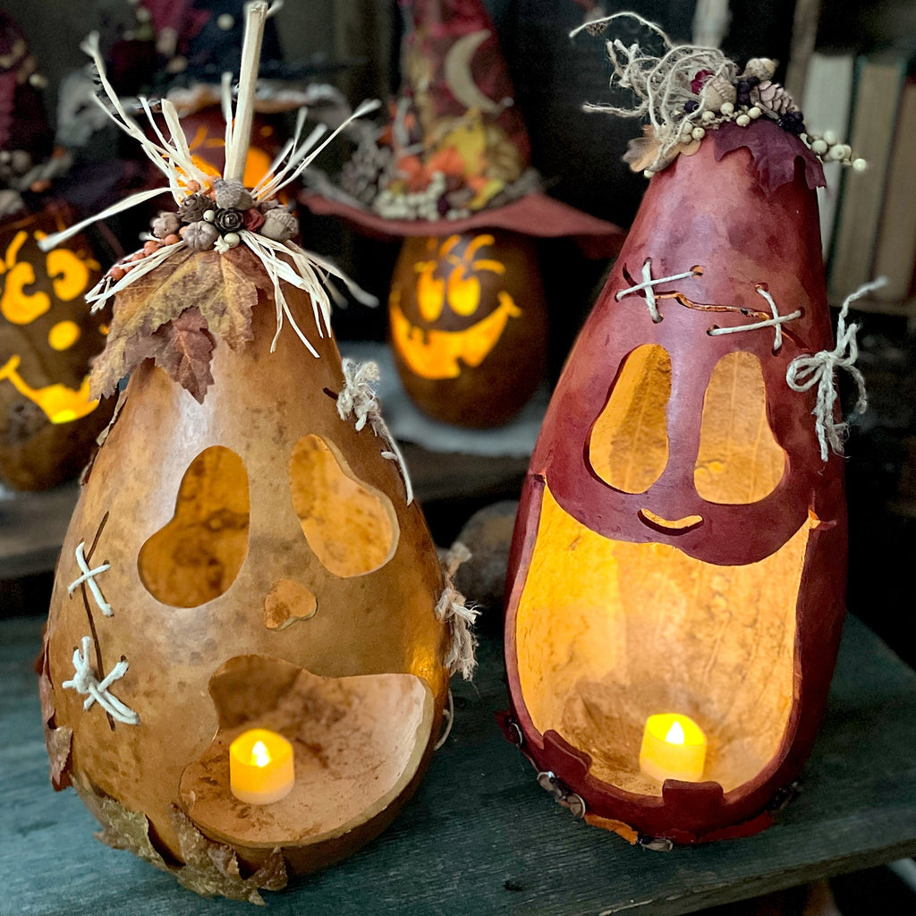 Two decorative gourds with candle lights inside, set against a Halloween-themed background.