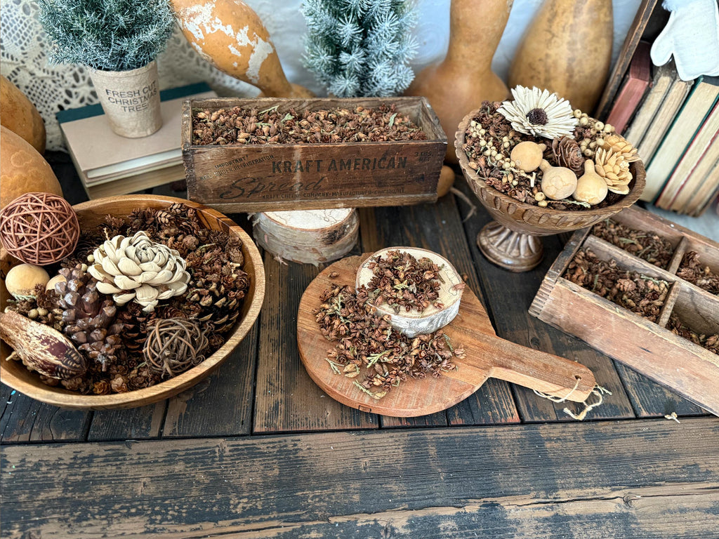 Decorative items including a wooden box, potted plants, and decorative objects on a rustic wooden table.