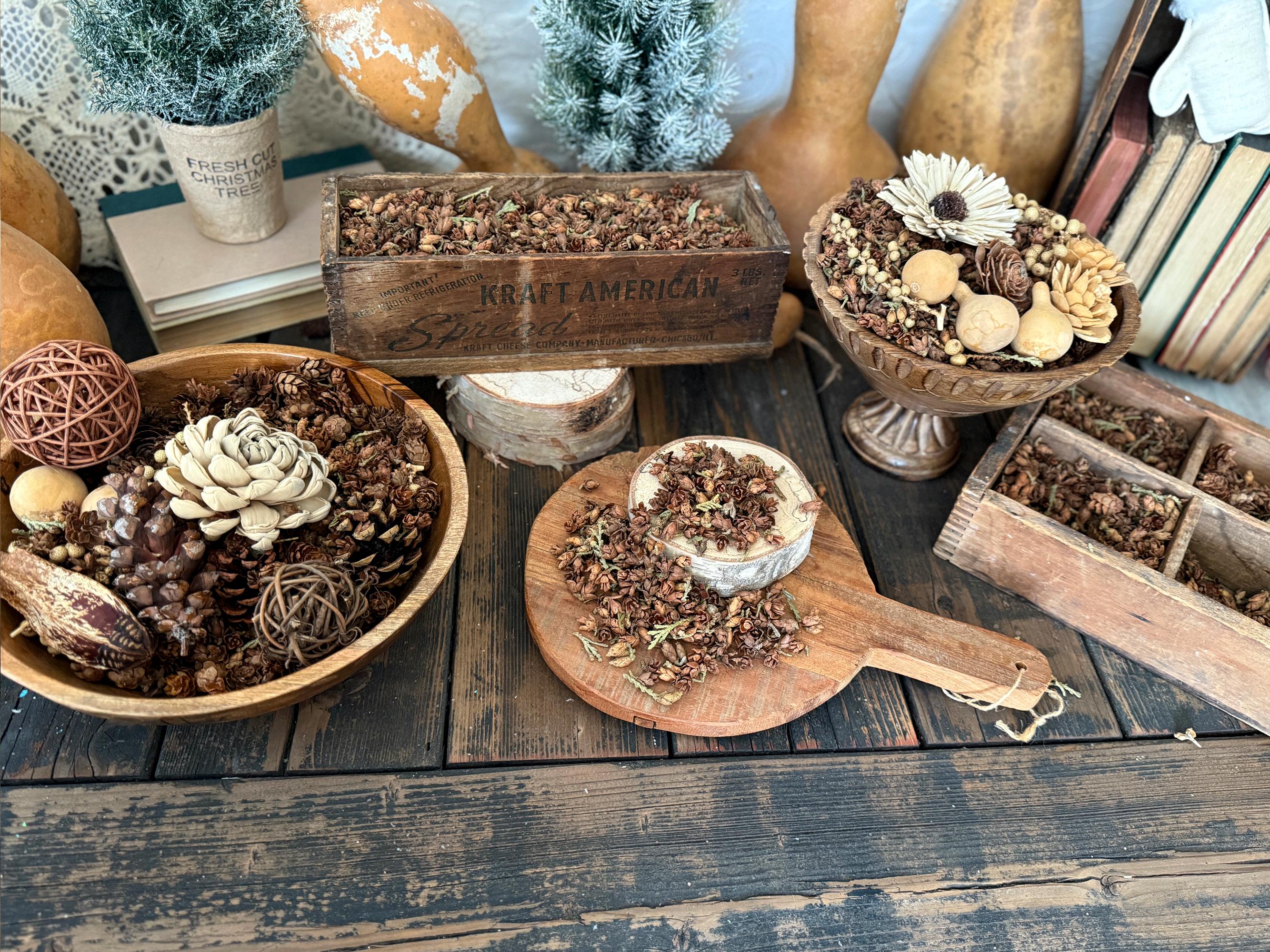 Decorative items including a wooden box, potted plants, and decorative objects on a rustic wooden table.