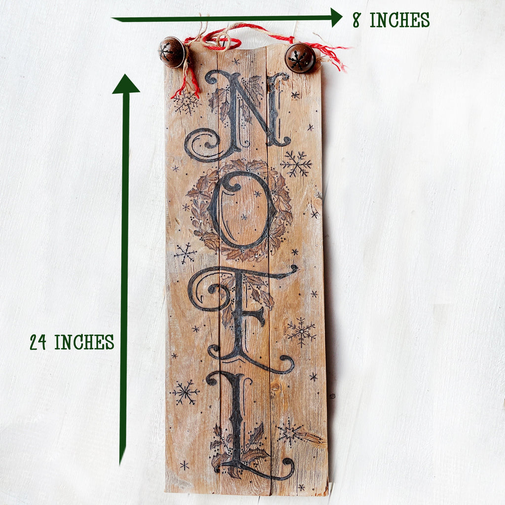 Wooden sign with 'NOEL' text and measurements on a white background