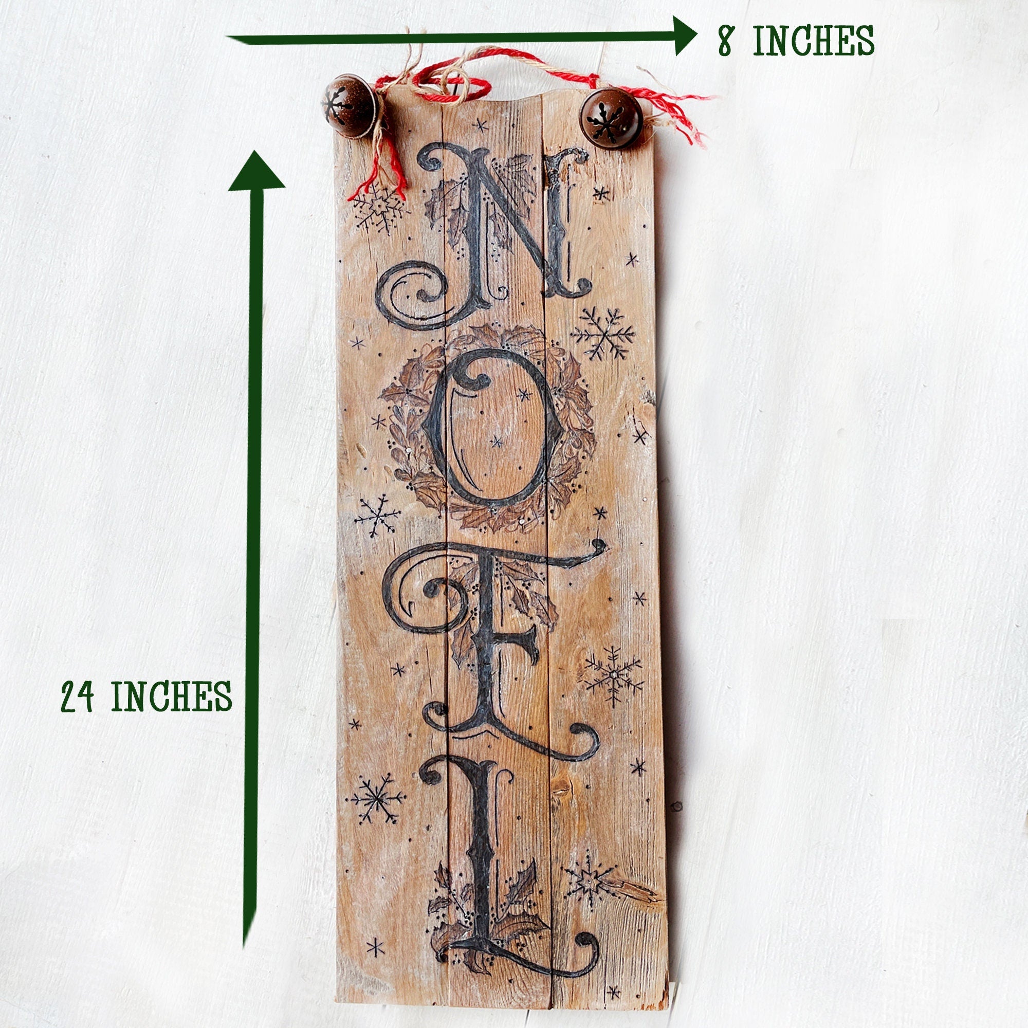 Wooden sign with 'NOEL' text and measurements on a white background