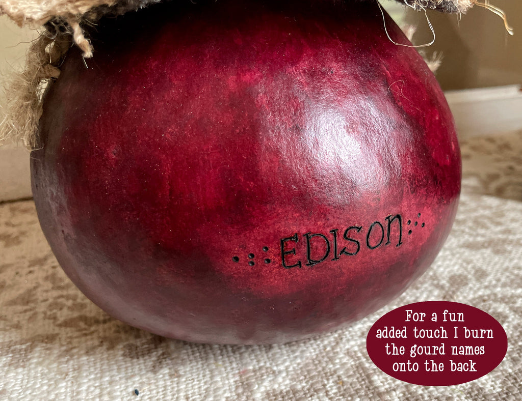 Purple gourd with 'Edison' engraved on a textured surface