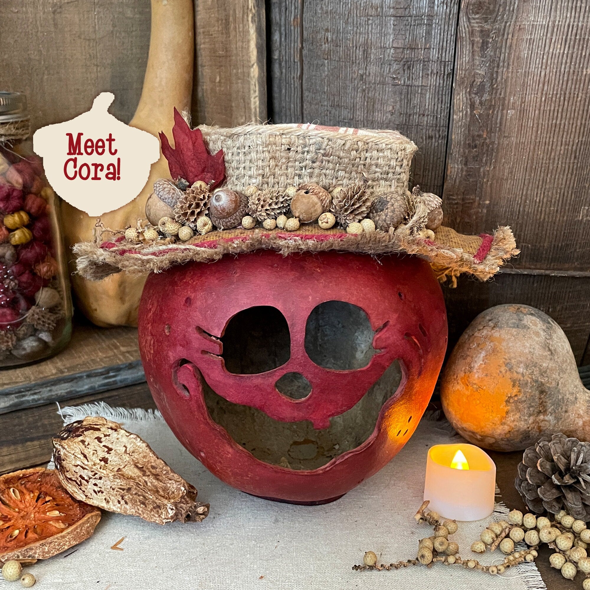 Decorative pumpkin with a top hat and autumnal elements on a rustic background