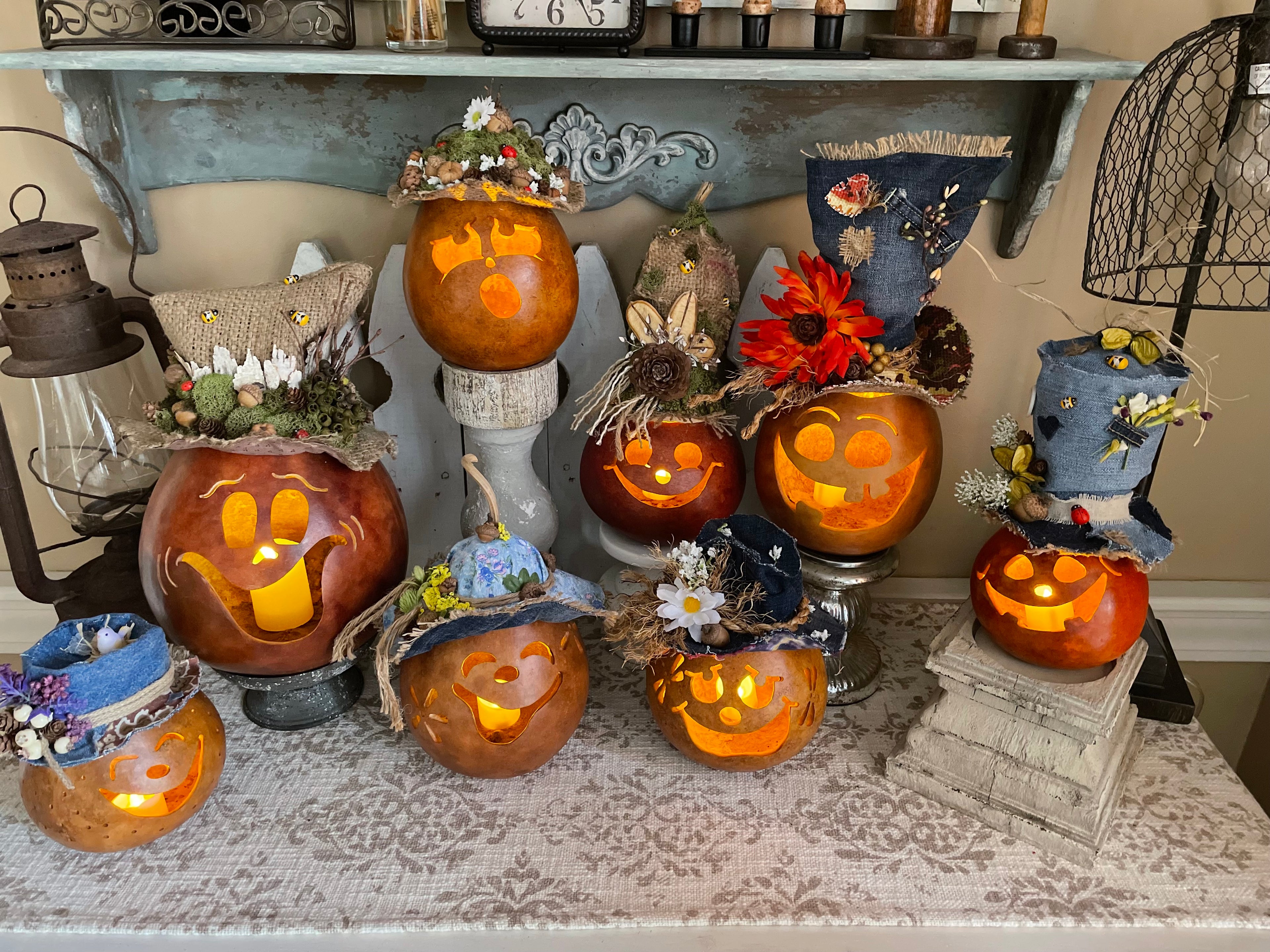 Decorative Halloween pumpkins with unique designs on a table.