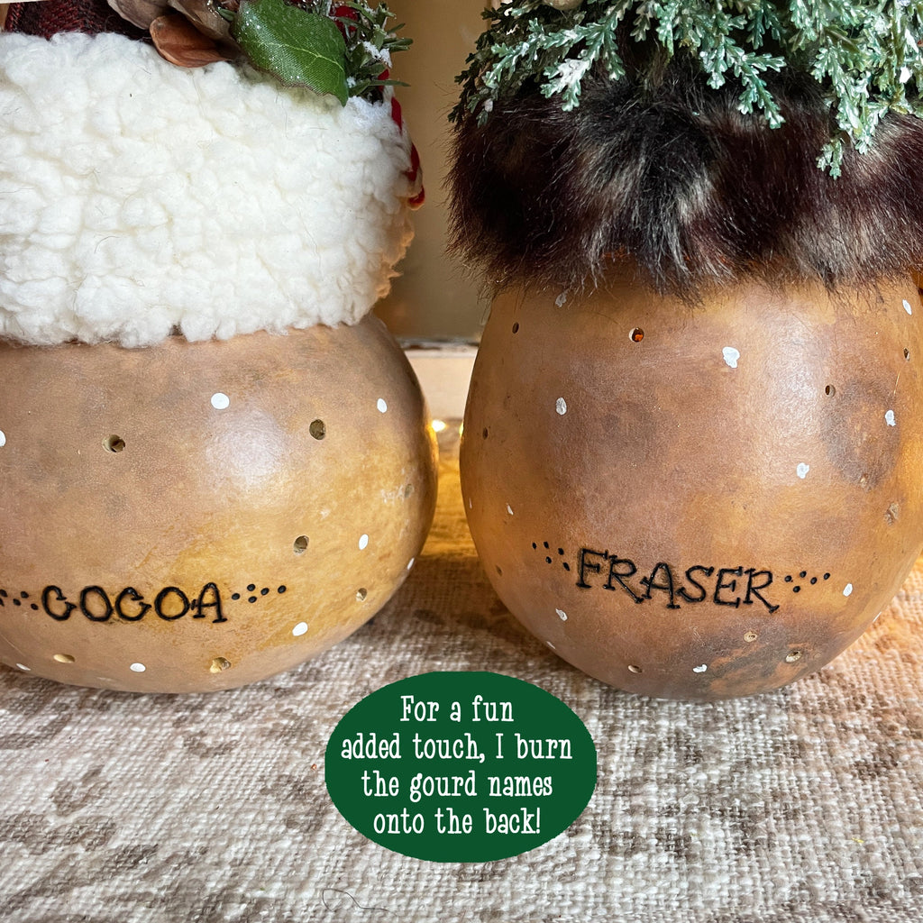 Two decorative gourds with 'Cocoa' and 'Fraser' names on a textured surface.