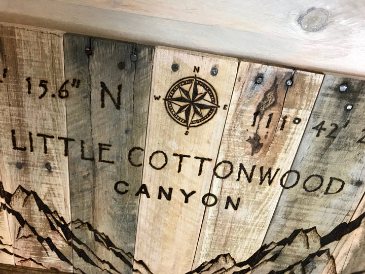 Wooden plaque with engraved coordinates and 'Little Cottonwood Canyon' text