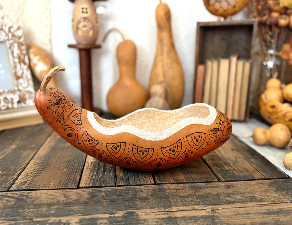 Decorative gourd with intricate patterns on a wooden surface
