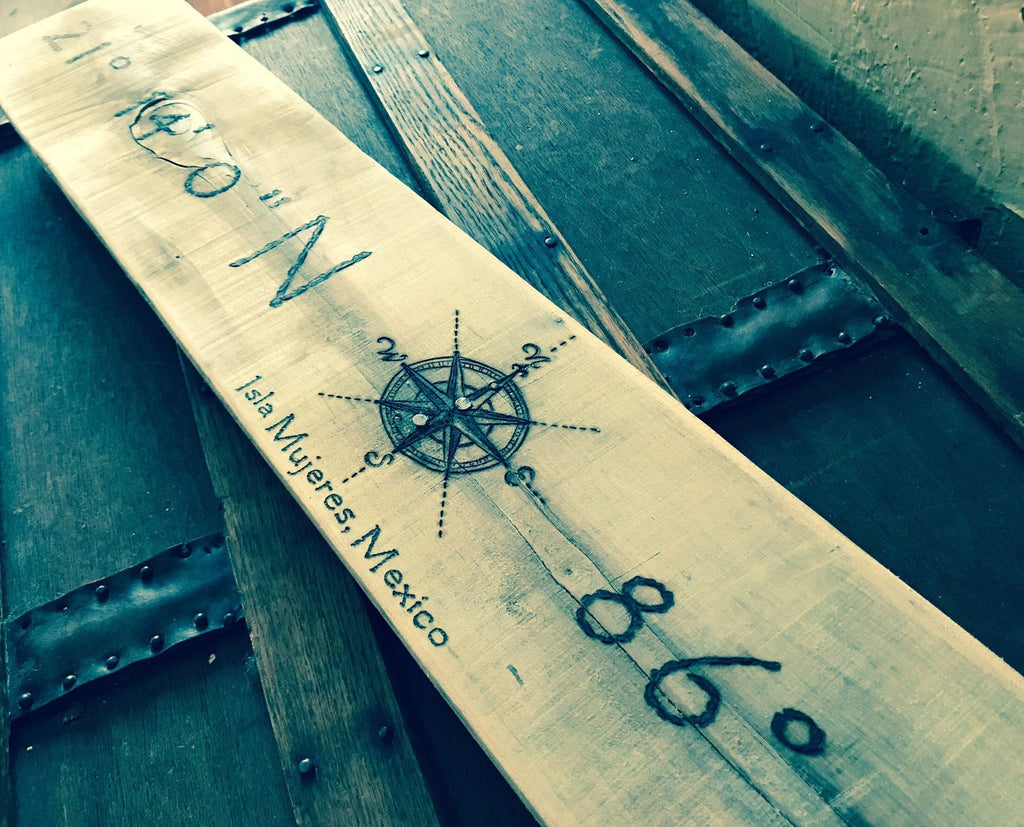 Wooden ruler with compass rose and text on a wooden surface