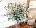 Holiday eucalyptus bouquet with red berries.  