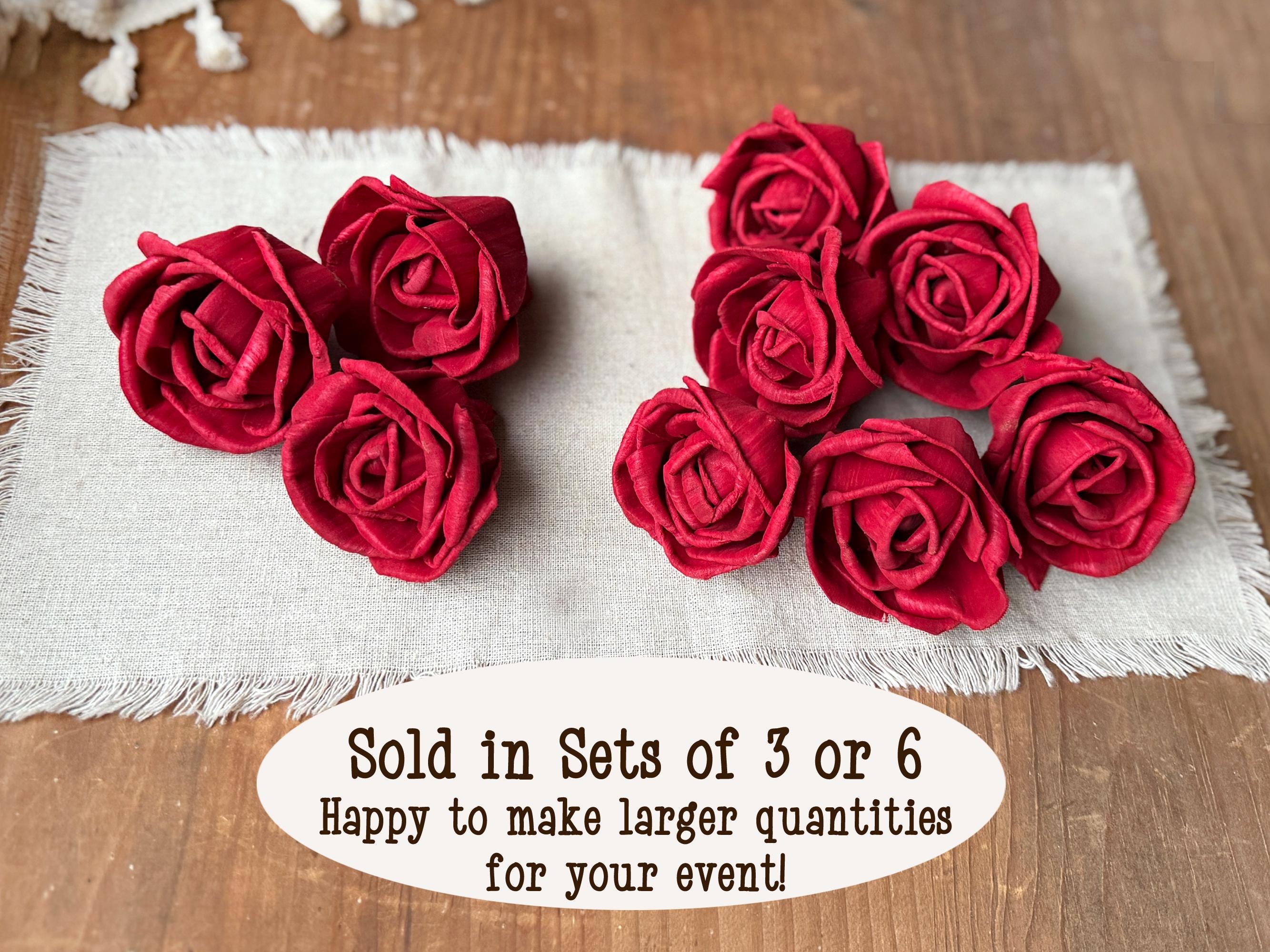 Red roses on a white fabric with text about quantity options.