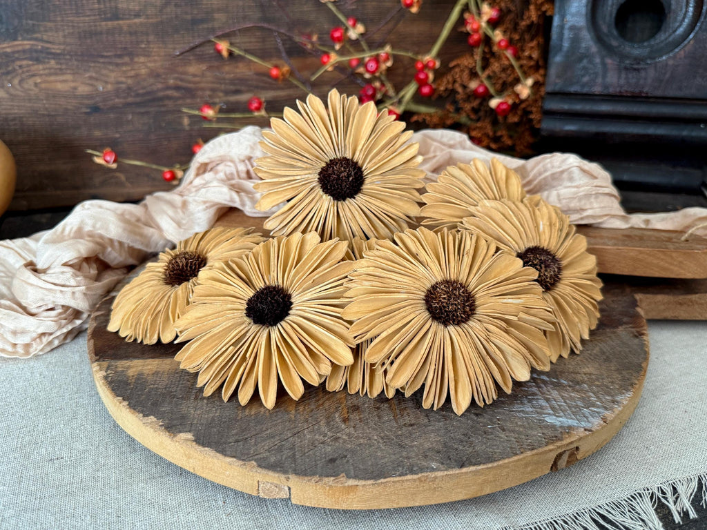 Decorative sunflower-shaped items on a wooden board with a rustic background.