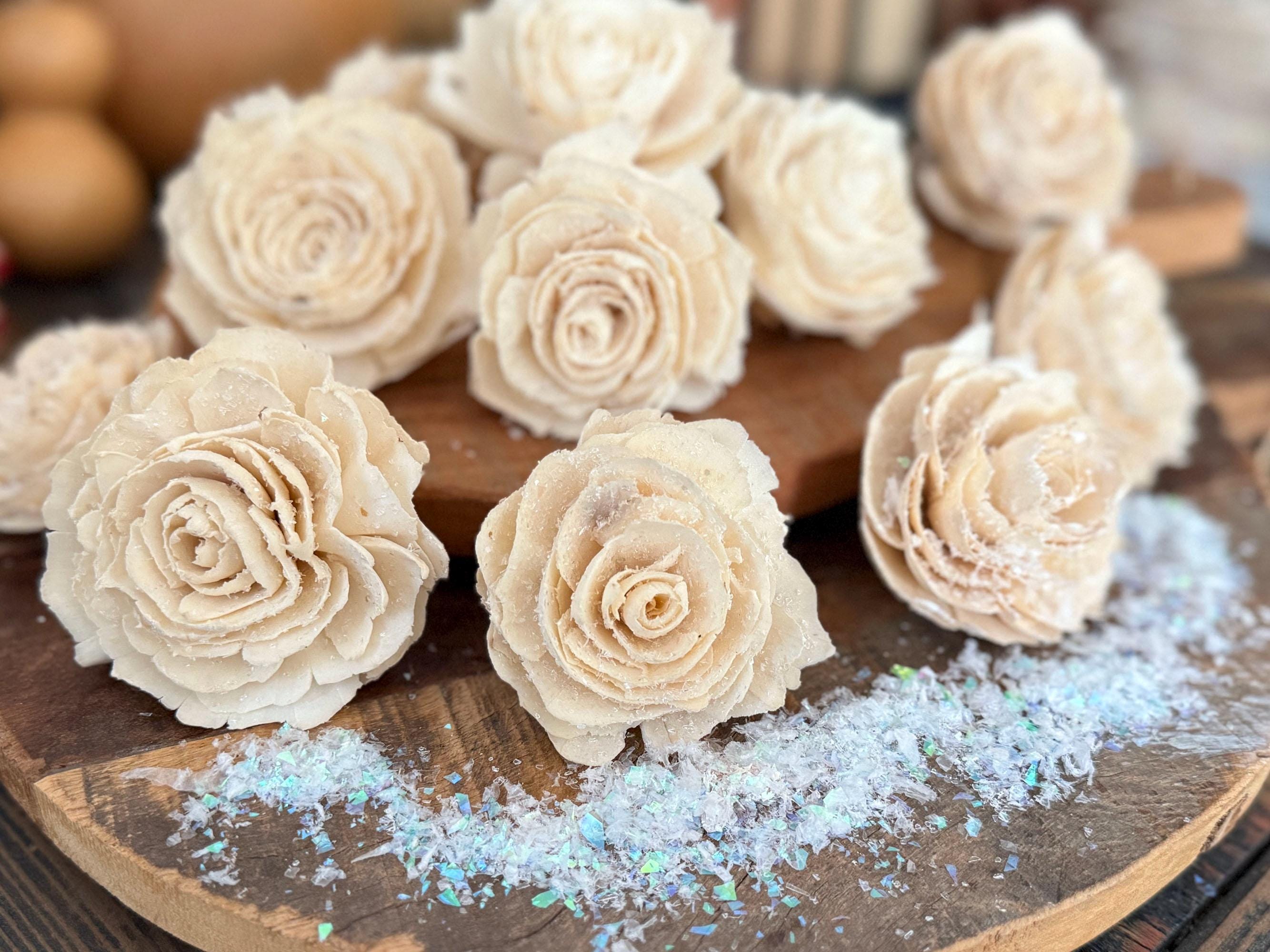Decorative beige flowers on a wooden surface with a blurred background