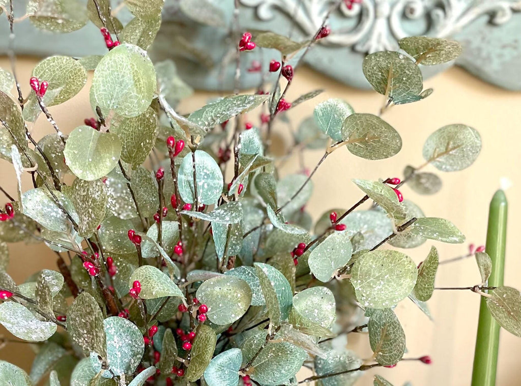 Decorative greenery with red berries on a blurred background