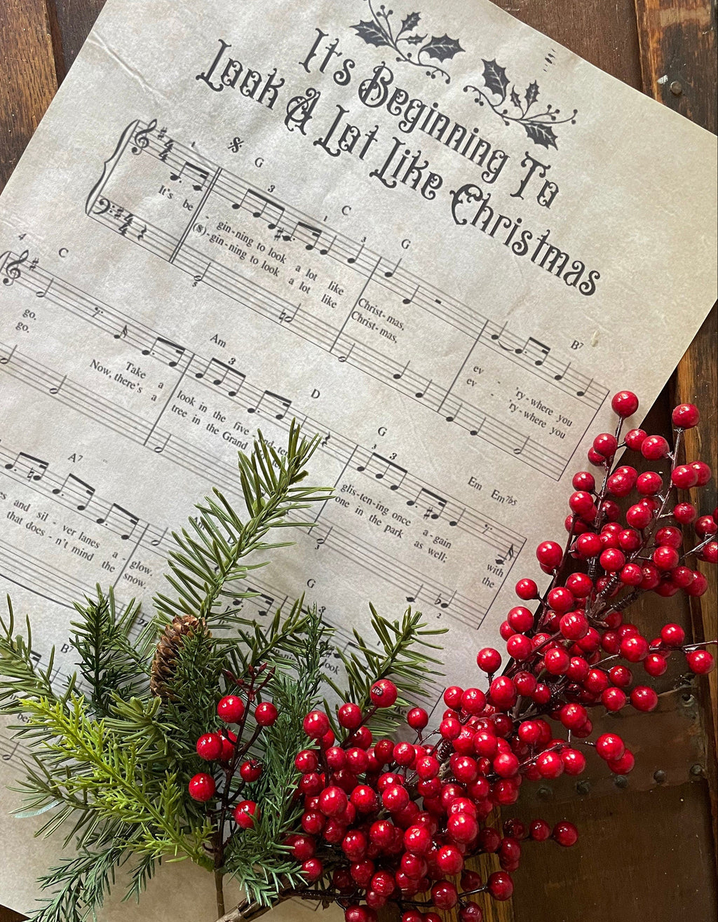 Sheet music with Christmas decorations on a wooden surface