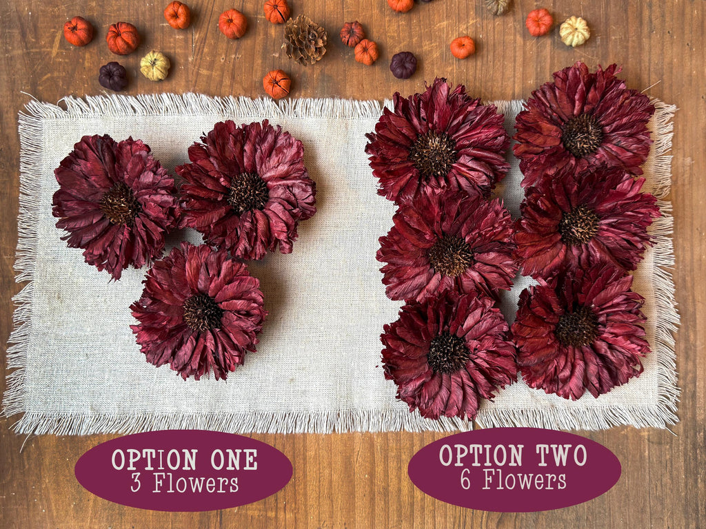 Red flowers arranged on a textured white surface with options labeled '3 Flowers' and '6 Flowers' on a wooden background.