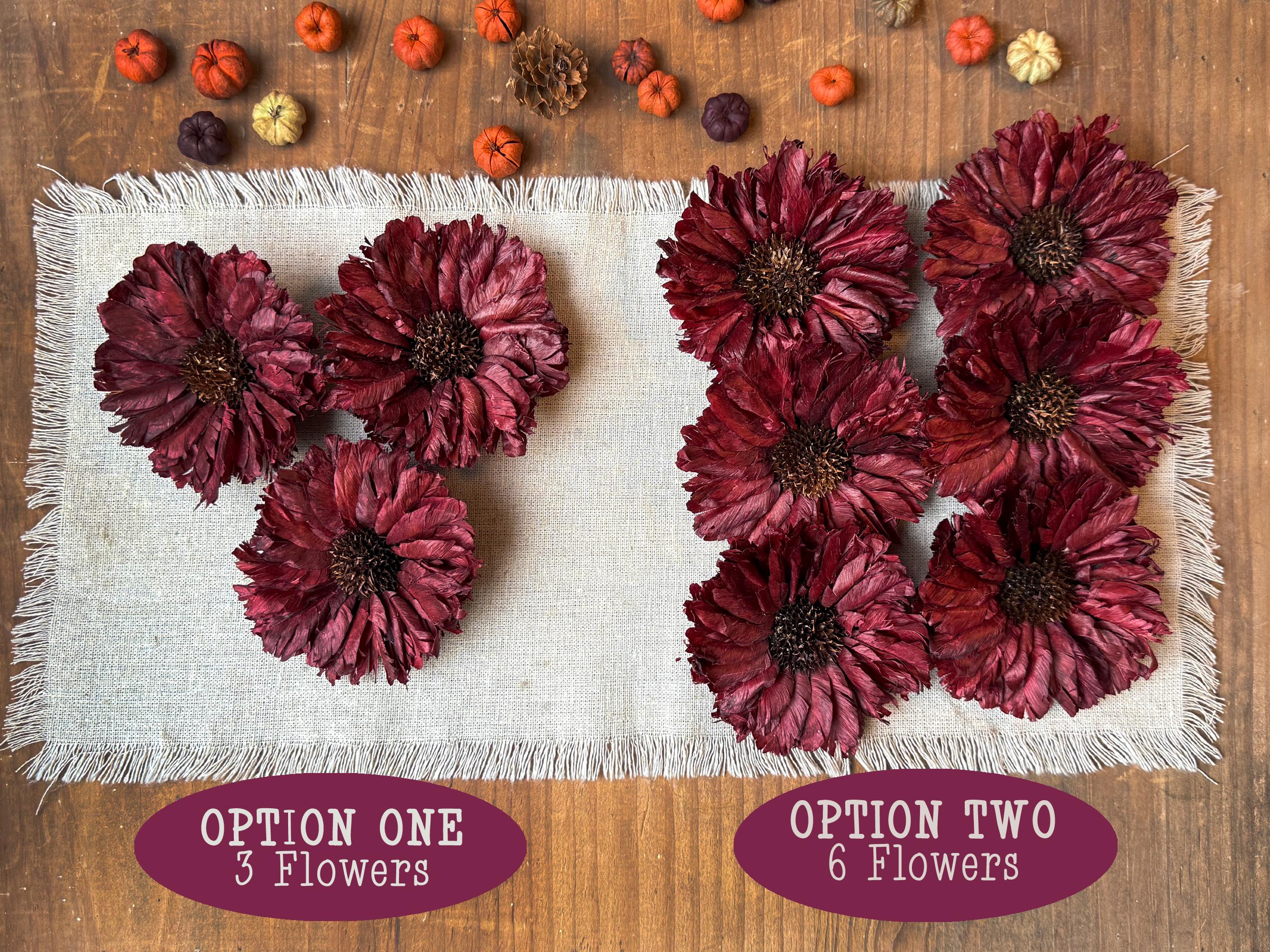 Red flowers arranged on a textured white surface with options labeled '3 Flowers' and '6 Flowers' on a wooden background.