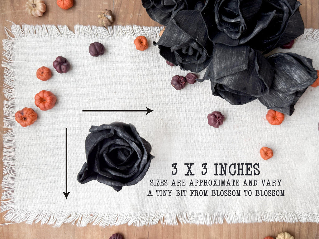 Black wood flowers on a white fabric background with measurements indicated.