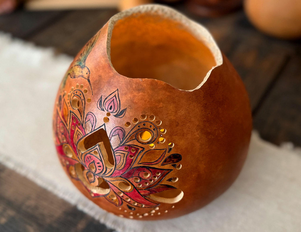 Decorative gourd with intricate designs on a wooden surface