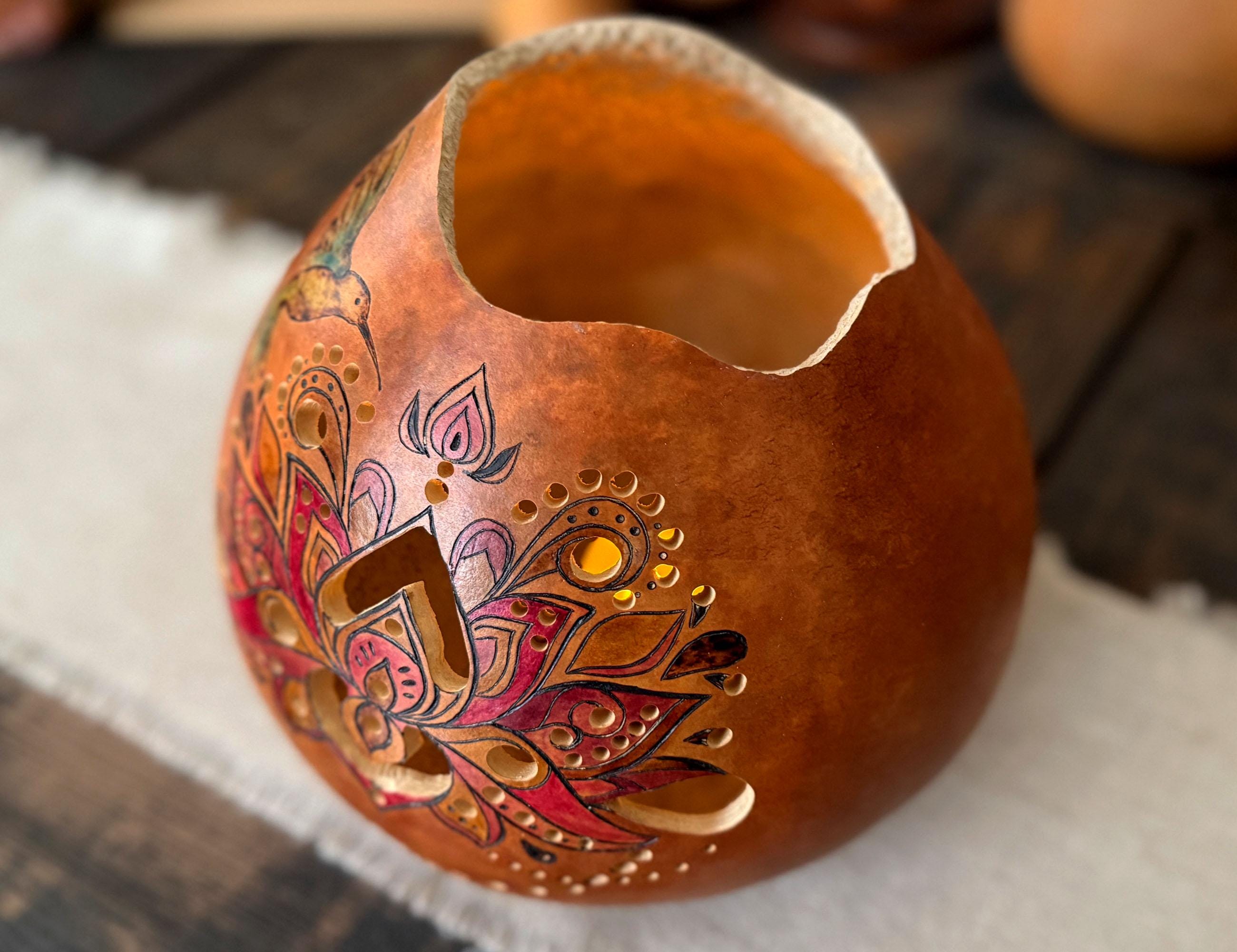 Decorative gourd with intricate designs on a wooden surface