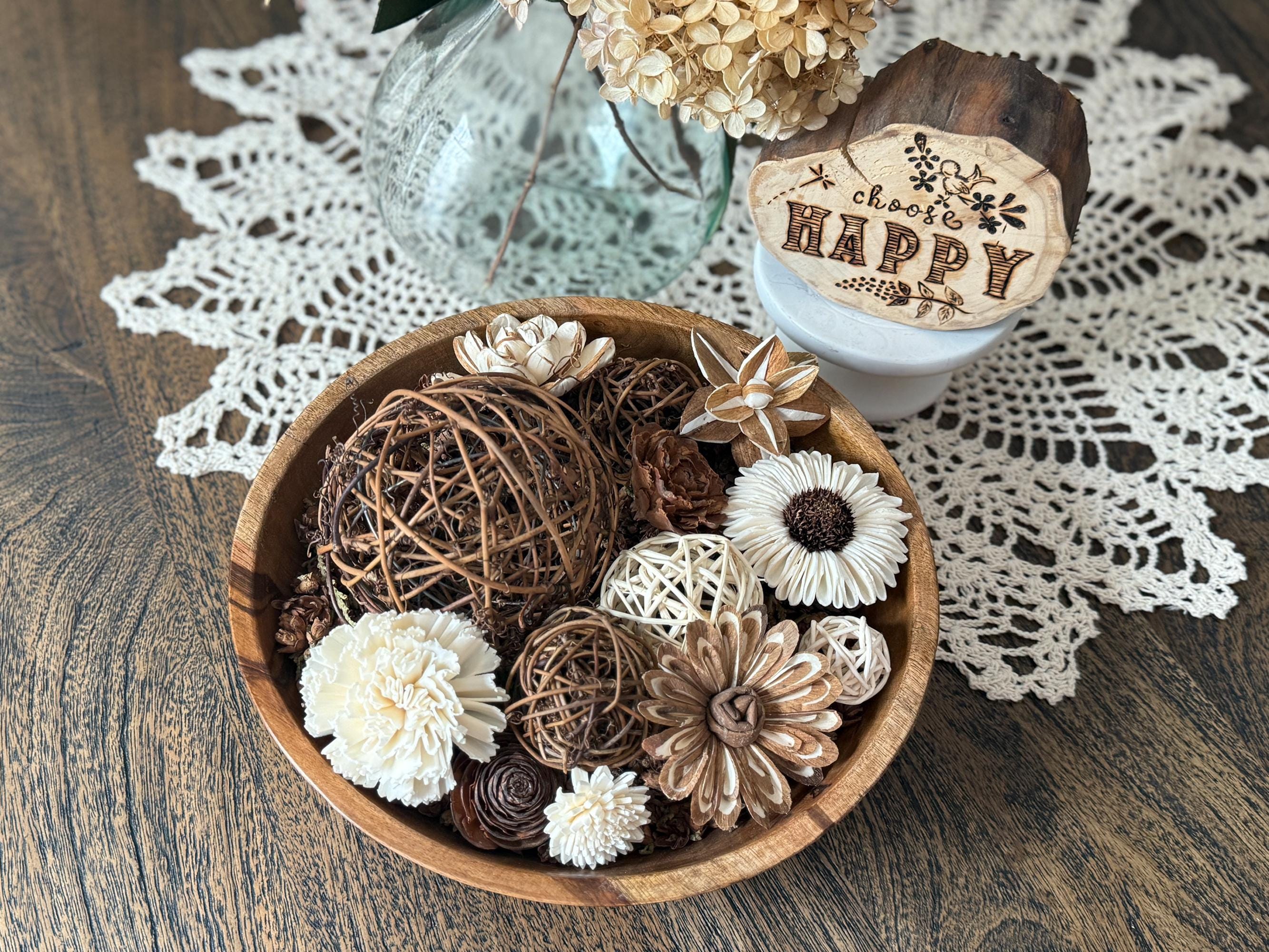 Decorative wood bowl with flowers and a wooden block on a doily