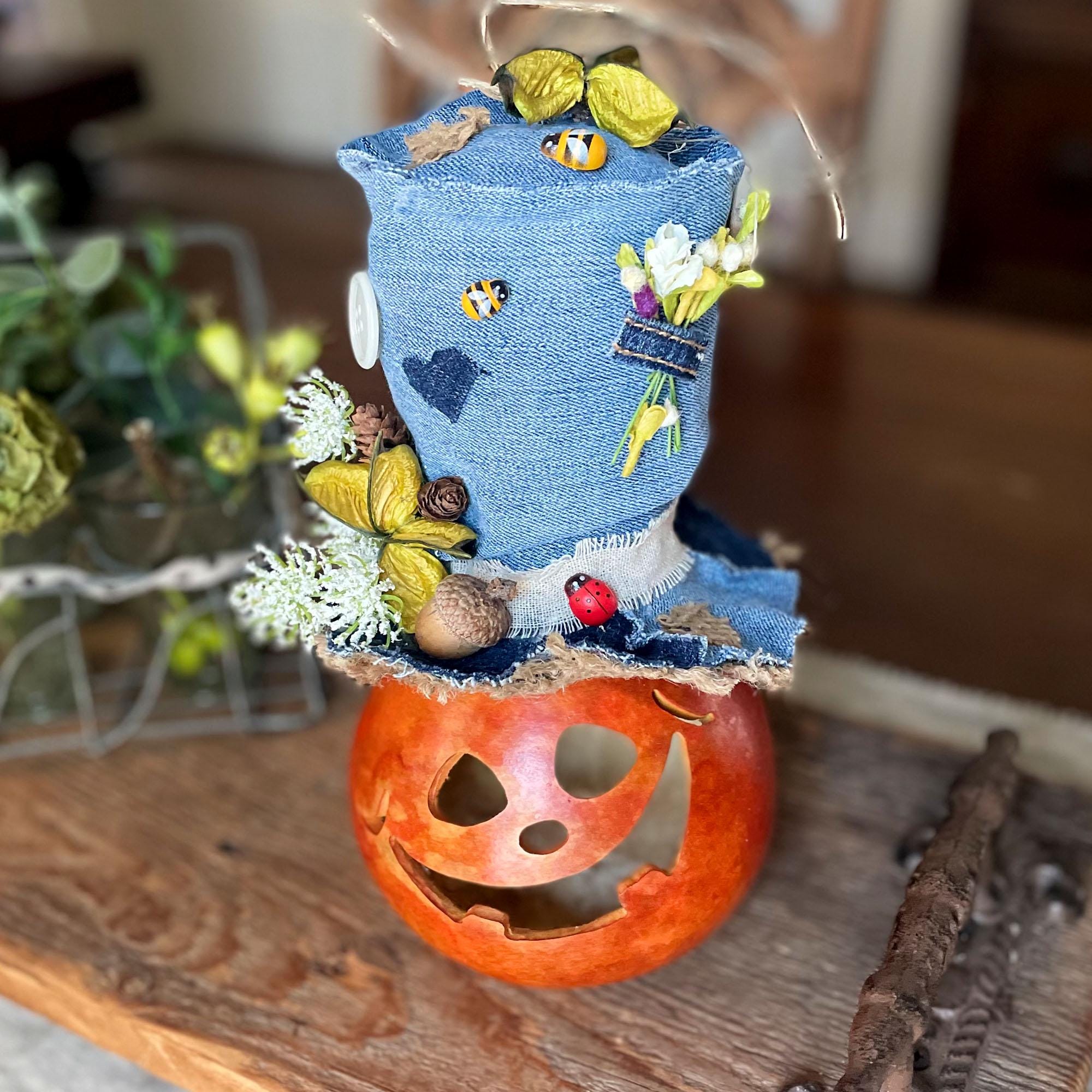 Decorative item with denim top and pumpkin base on a wooden surface