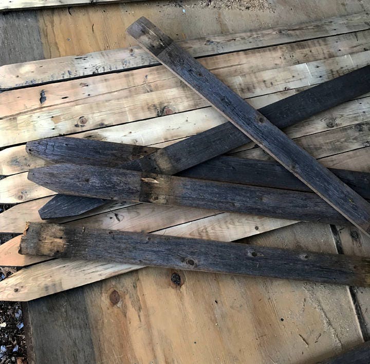 Stack of old, weathered wooden planks on a wooden surface
