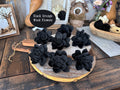 Black grunge wood flowers on a wooden surface with decorative items in the background.